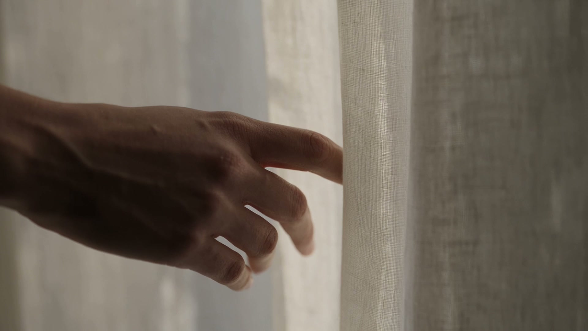 Hand interacting with light fabric